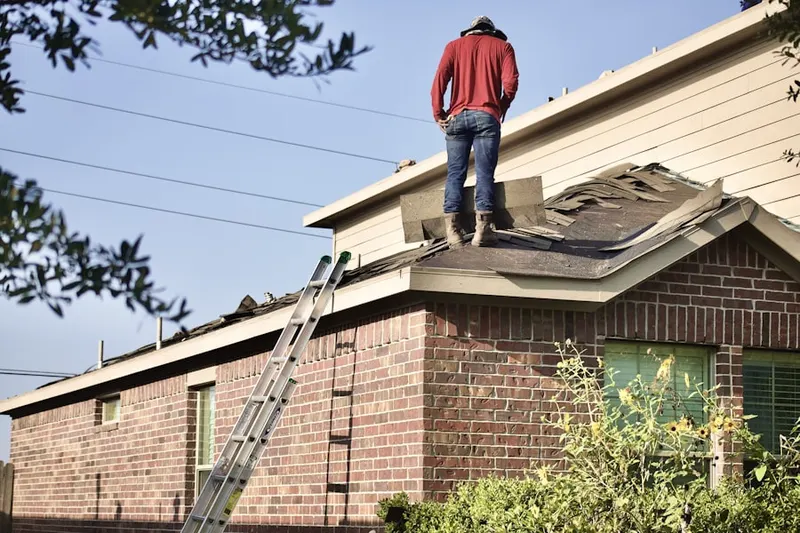 Professional roofer working on a residential roof in Wilmington Manor
